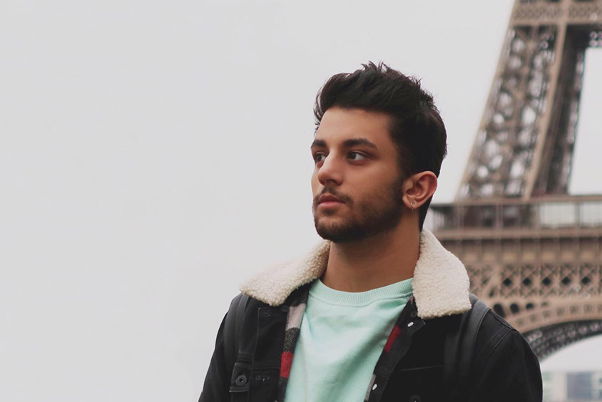 A portrait of Ehsan Habib in front of the eiffel tower