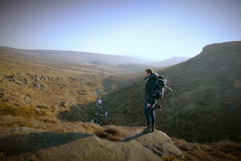 Ed standing on a rock while filming in the Peak District National Park