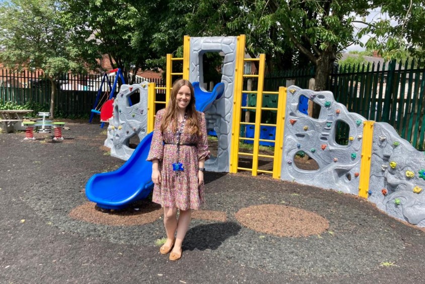 Elizabeth is standing in a school playground