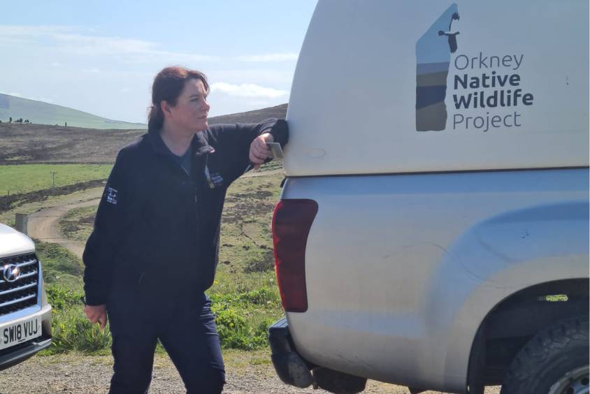 Hannah Read leaning against a van