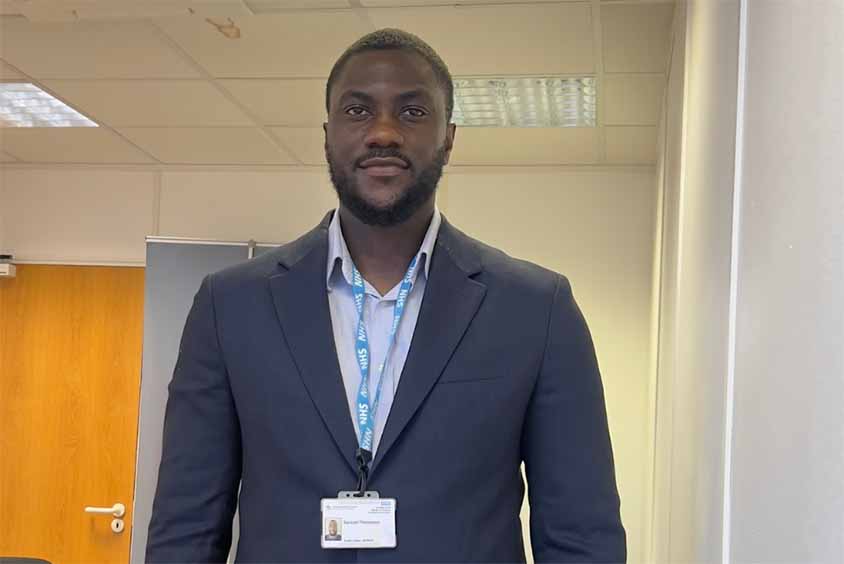 Student in the workplace looking at directly at the camera dressed in smart office wear.