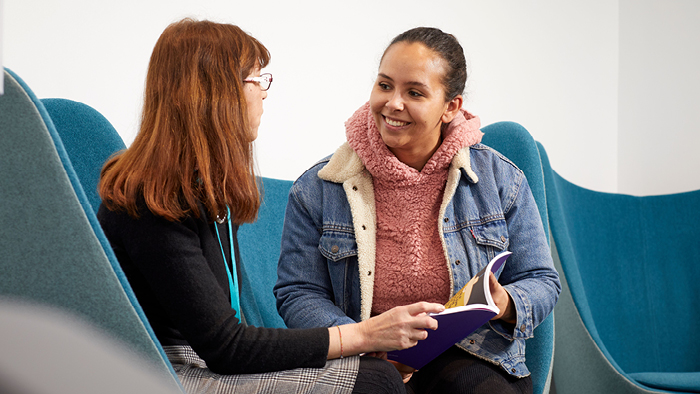 Student receiving support while sat down with tutor