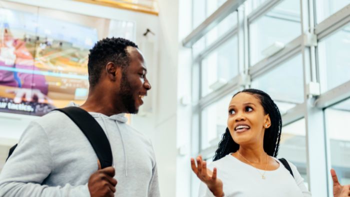 Two Hallam students walking through campus