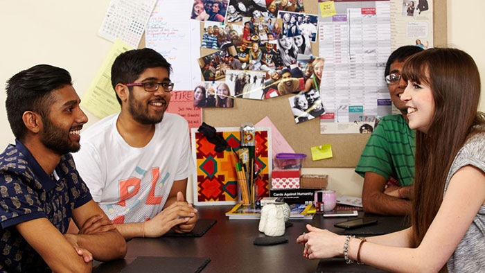 Students sat around a coffee table