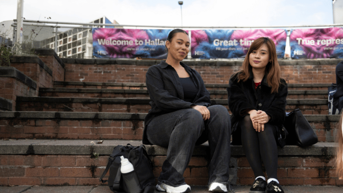 Two students sat in Hallam Square.