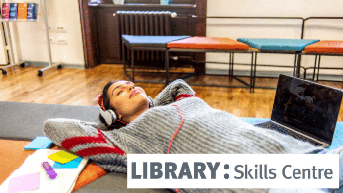 photo of a student lying down with headphones on