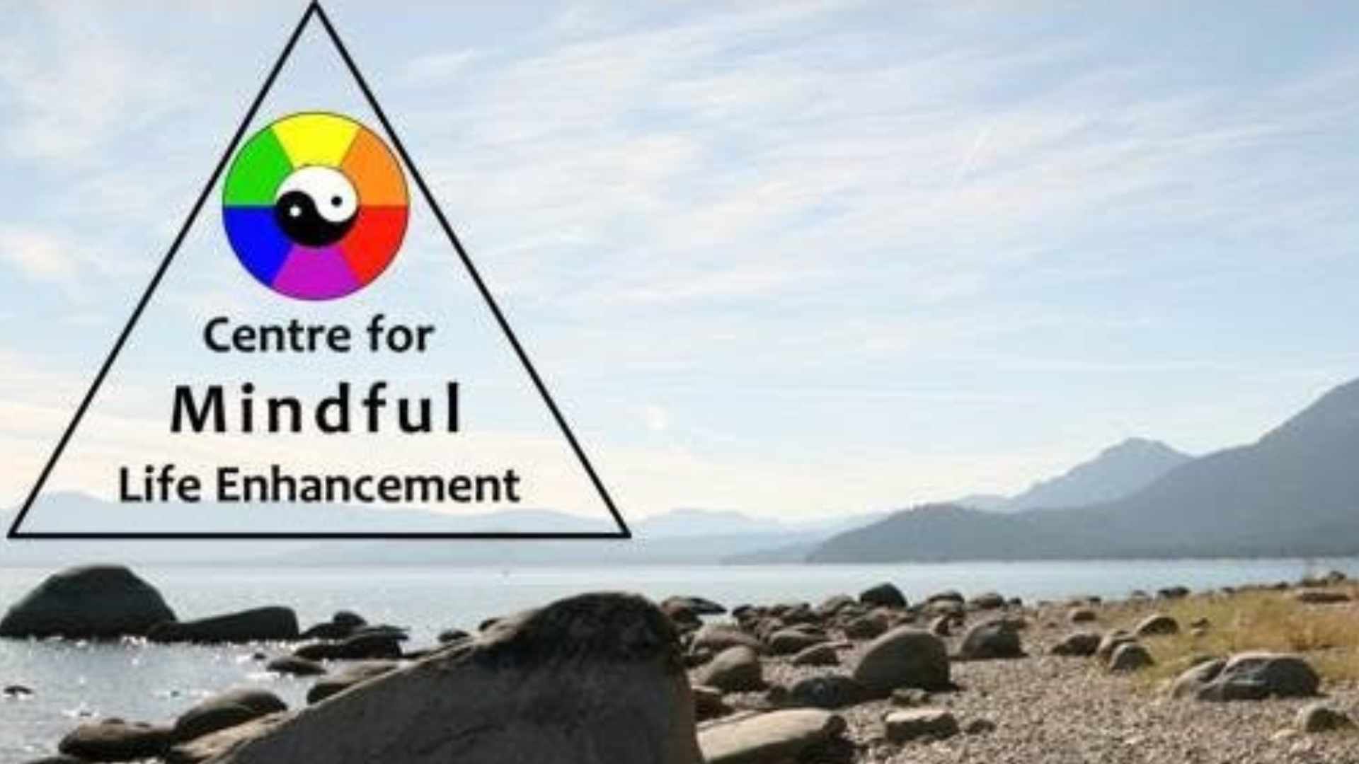 The centre for mindful enhance logo over a lake view with mountains