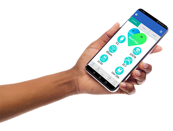 An image of a hand holding a phone displaying the Well.Me app