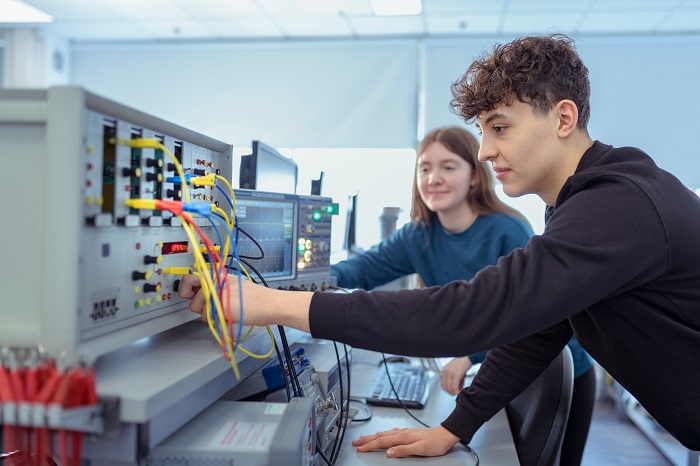 two students connecting wires
