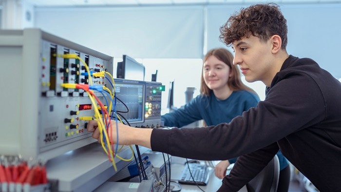 Two students connecting wires