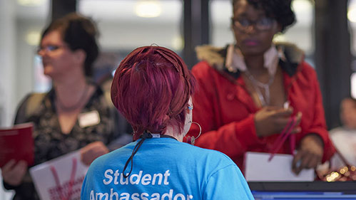 A student ambassador talking to prospective students 