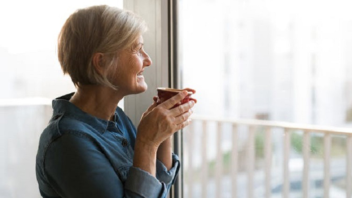 An older lady sitting by a window